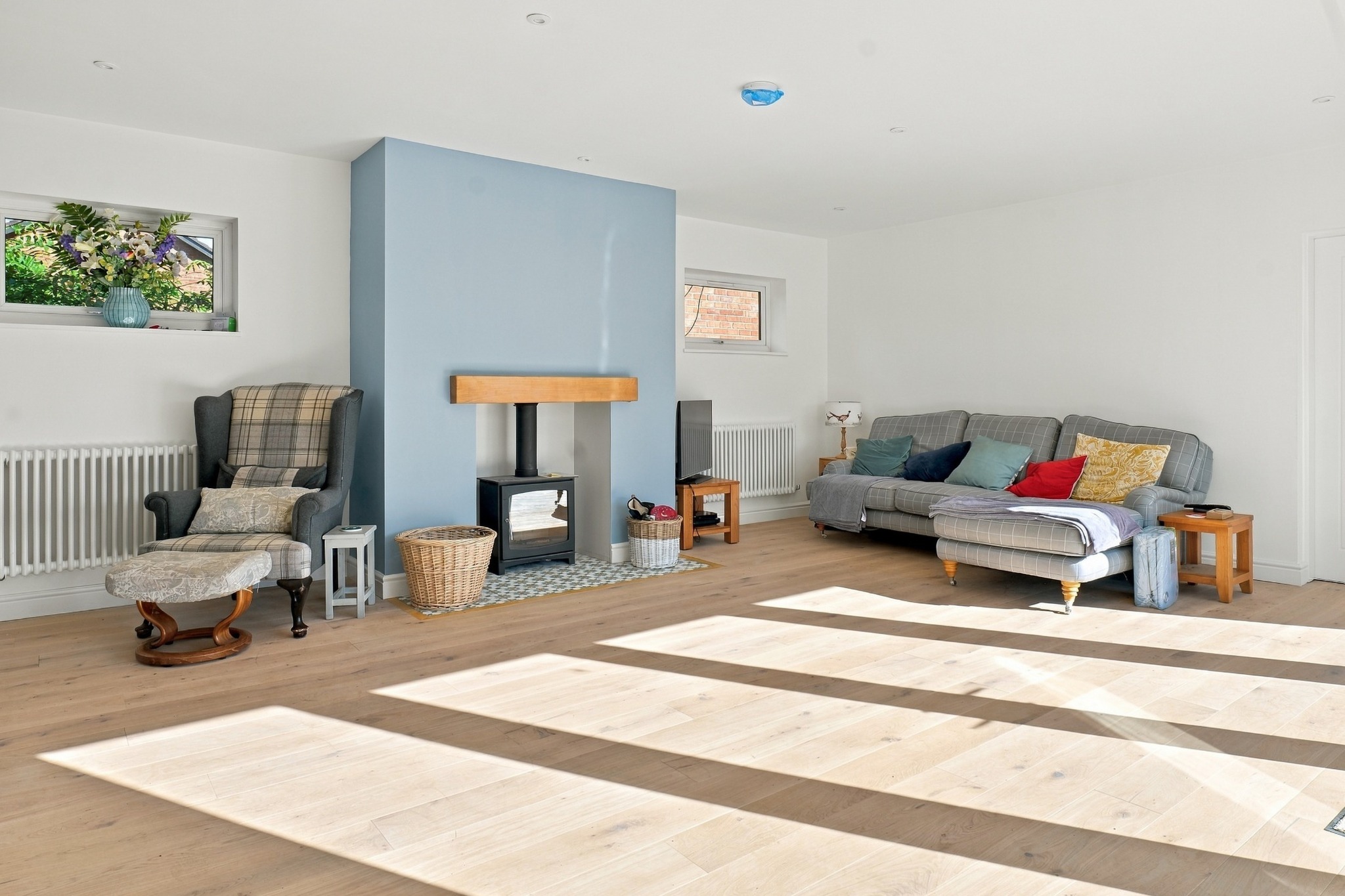 Living room with wood-burning stove and pale flooring — Cobbetts Way, Wilmslow